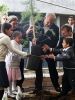 Prime Minister Benjamin Netanyahu help plant a tree in a West Bank settlement