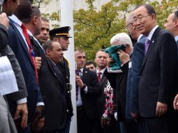 Palestinian president Mahmud Abbas kisses the Palestinian flag as Secretary General Ban Ki-moon looks on during the flag raising ceremony on September 30, 2015 at the UN in New York.