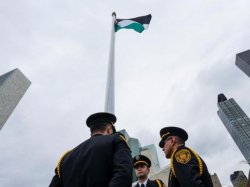 Media and UN Honor Guard members gather during the Palestinian flag raising ceremony on September 30, 2015 at the UN in New York.