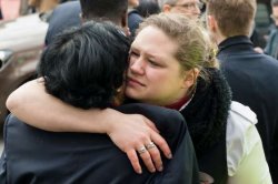People react outside Brussels airport after explosions rocked the facility