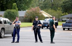 Police officers block off a road after a shooting of police in Baton Rouge, Louisiana, U.S. July 17, 2016.