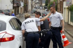 French police officers seal off access to the scene of an attack in Saint-Etienne-du-Rouvray, France.