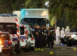 French police forces and forensic officers stand next to a truck July 15, 2016 that ran into a crowd celebrating the Bastille Day national holiday on the Promenade des Anglais killing at least 60 people in Nice, France, July 14.