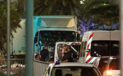 French police forces and forensic officers stand next to a truck July 15, 2016 that ran into a crowd celebrating the Bastille Day national holiday on the Promenade des Anglais killing at least 60 people in Nice, France, July 14.