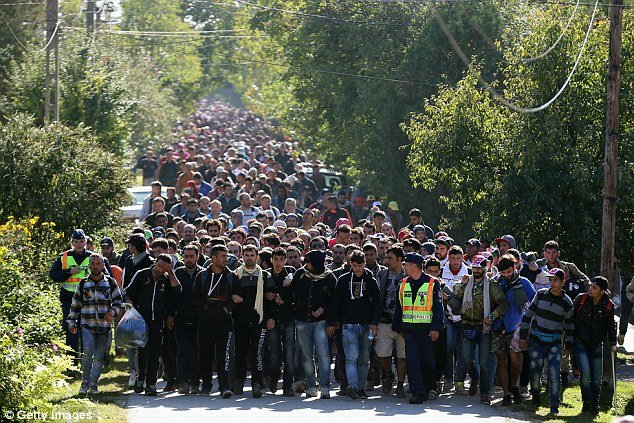 Jean-Claude Juncker called for all borders across Europe to be opened, despite the chaos caused over the last year from the flood in refugees fleeing Syria. (Hundreds of migrants are pictured at the Hungarian and Austrian border last year.)