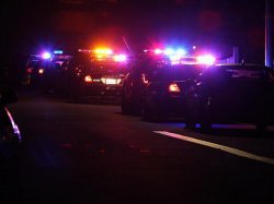 Police cars ine the scene near the corner of 39th Street and Boston Avenue in San Diego near where two police officers were shot Thursday night, July 28, 2016.