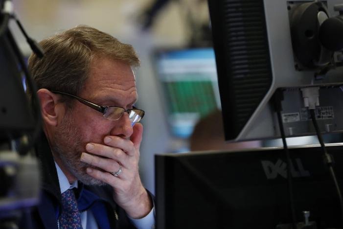 A trader watches his screen on the floor of the New York Stock Exchange (NYSE) shortly before the close of trading in New York, U.S., December 13, 2016. REUTERS/Lucas Jackson