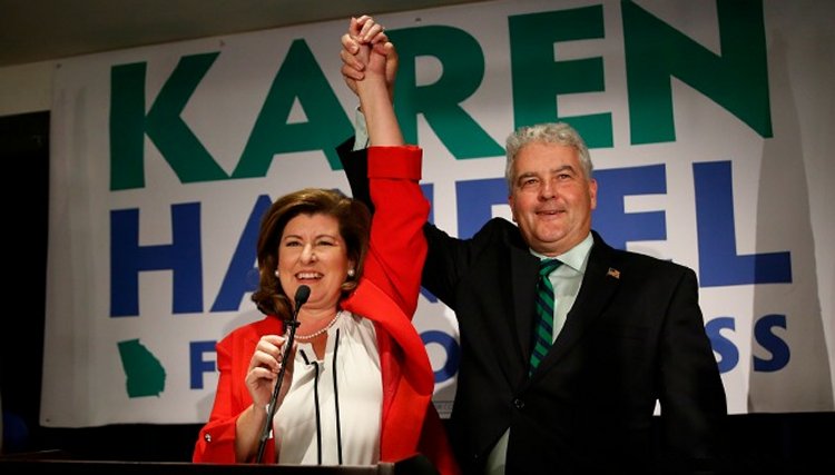 Republican candidate for Georgia's 6th District Congressional seat Keran Handel celebrates with her husband Steve as she declares victory during an election-night watch party Tuesday, June 20, 2017, in Atlanta.