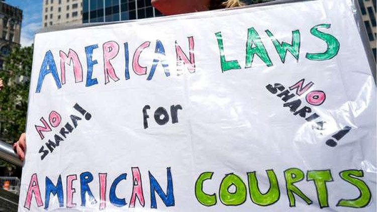 Demonstrators gathered to protest against Islamic law take part in a rally Saturday, June 10, 2017, in New York. Marches against Islamic law were planned Saturday in more than two dozen cities across the United States, but scholars and others say the protesters are stoking unfounded fears and promoting a distorted and prejudiced view of the religion. (AP Photo/Craig Ruttle)