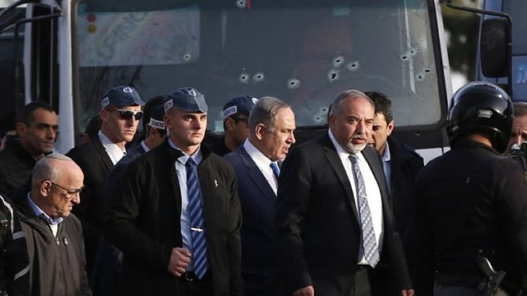 Prime Minister Benjamin Netanyahu, center, and Defense Minister Avigdor Lieberman, to his left, visit the site of a vehicle-ramming attack in Jerusalem on January 8, 2017.