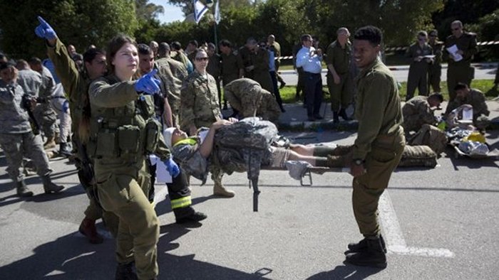 In this Tuesday, March 1, 2016 file photo, American servicemen and Israeli soldiers participate in a joint drill simulating a rocket attack at a base in Hatzor, central Israel. (AP Photo/Sebastian Scheiner, File)