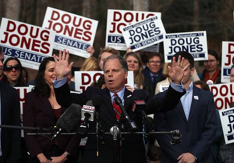 Doug Jones speaks to reporters after voting at Brookwood Baptist Church on Tuesday in Mountain Brook, Alabama.