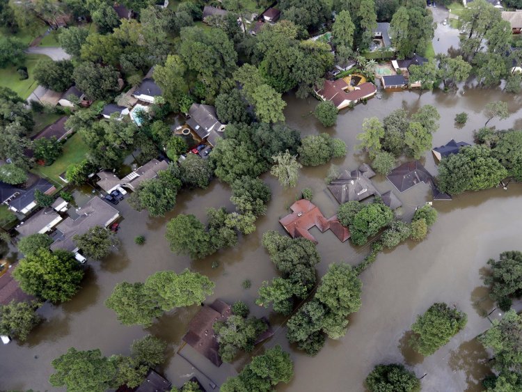 Homes are surrounded by floodwaters from Tropical Storm Harvey Tuesday, Aug. 29, 2017, in Spring, Texas. AP Photo/David J. Phillip