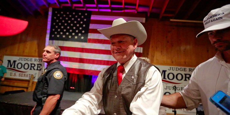 Moore with supporters after he spoke at a rally Monday in Fairhope, Alabama. AP Photo/Brynn Anderson