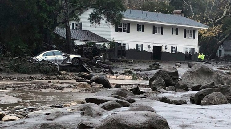 Mud and debris flow down a road due to heavy rain in Montecito on Tuesday. (Mike Eliason/Santa Barbara County Fire Dept. via Associated Press)