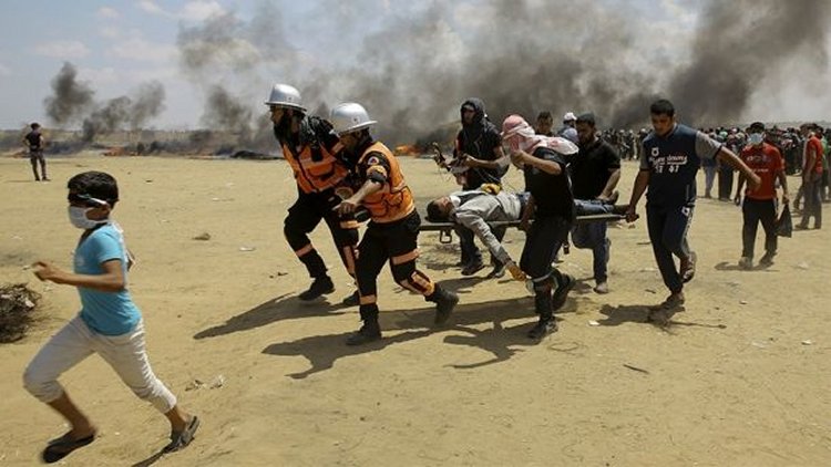 May 14, 2018: Palestinian medics and protesters evacuate a wounded man during a protest at the Gaza Strip's border with Israel, east of Khan Younis, Gaza Strip. (AP)