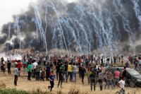 Tear gas comes down upon Palestinian protestors at Gaza/Israel border