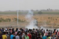 Tear gas comes down upon Palestinian protestors at Gaza/Israel border