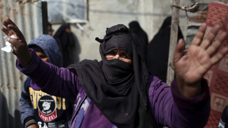 Relatives mourn one of two Palestinian teenagers who were killed Saturday trying to infiltrate Israel, during his funeral in the Rafah refugee camp, southern Gaza Strip, Sunday, Feb. 18, 2018. The Israeli military said it struck 18 targets in Gaza early on Sunday, in response to an explosive device that wounded four Israeli soldiers, along the border with the territory. (AP Photo/ Khalil Hamra)