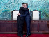 Kim Jong-un and Moon Jae-in hugging at their summit meeting in South Korea