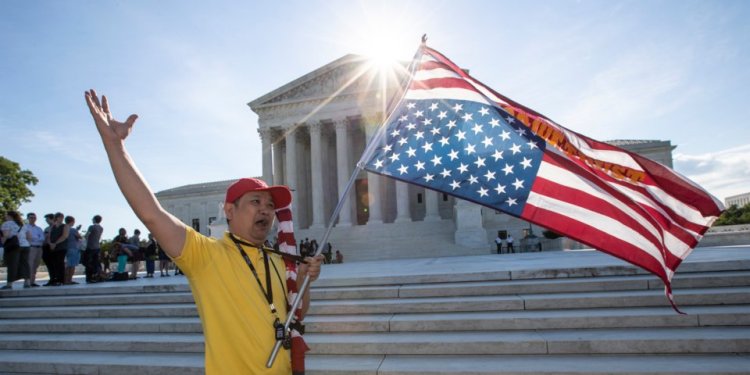 Penny Vu of Falls Church, Virginia, who immigrated to the US from Vietnam 22 years ago, demonstrates in front of the Supreme Court on June 25, 2018.AP Photo/J. Scott Applewhite