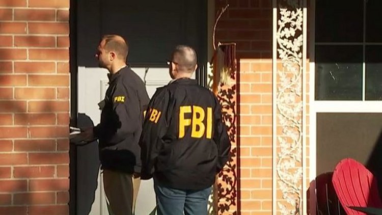 FBI agents can be seen in an Austin neighborhood after an explosion at a home left a teenager dead and a woman injured. (FOX 7)