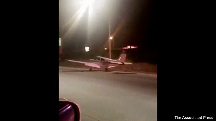This image made from a video provided by Dora Noriega shows a plane that landed on a freeway south of Los Angeles on Sunday, Jan. 28, 2018. The Costa Mesa Fire Department tweeted Sunday night that the plane landed safely, its occupants got out and that no injuries were reported. (Dora Noriega via AP)